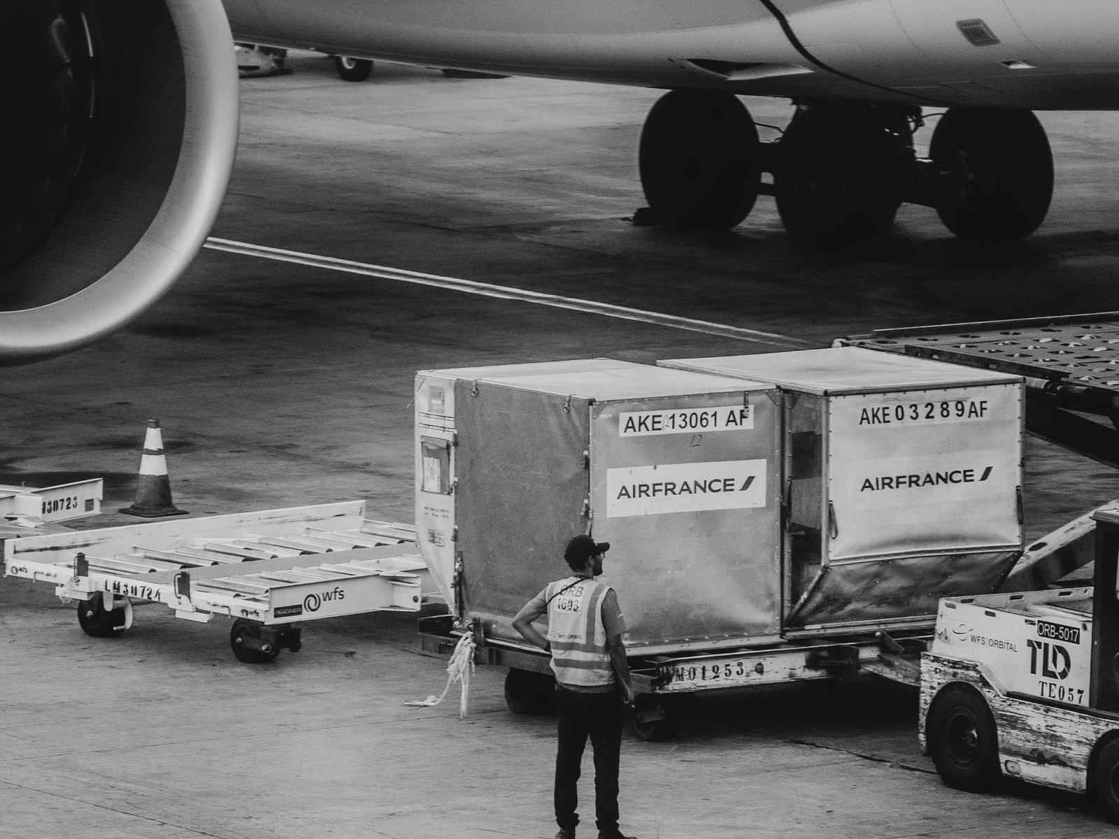 Air cargo containers on the ramp with ground handling equipment